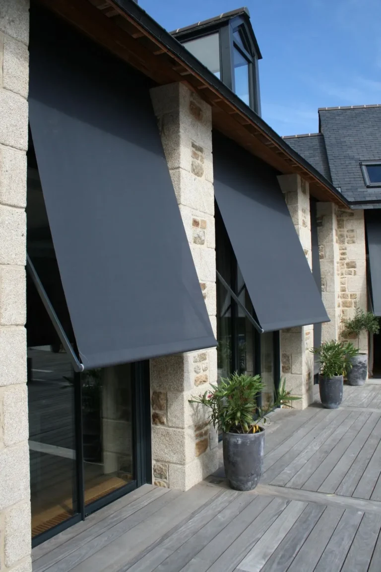 Drop-arm awnings on windows