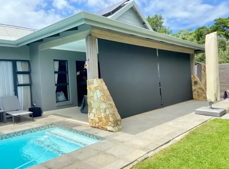 Custom curtains fitted in a Ballito home Outdoor blinds shading a Dolphin Coast patio beside a pool
