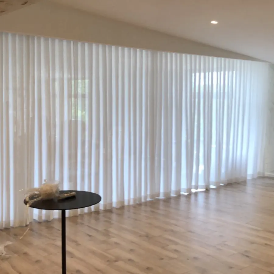 Sheer wave curtains on a ceiling track, made and installed by The Window Boutique